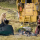 Pfeiffer sitting in the grass with a fire.